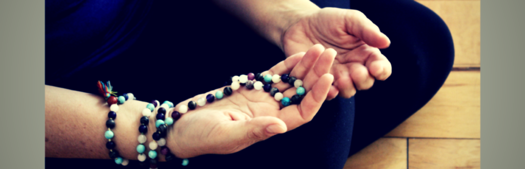mind body awareness prayer beads in hands